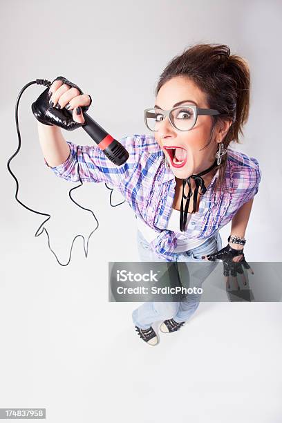 Nerdy Female Singer With Glasses Singing Loud Into Microphone Stock Photo - Download Image Now
