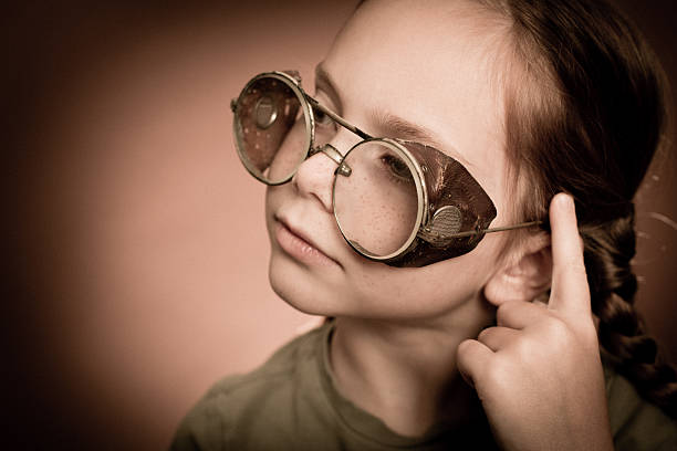 istock Thinking Little Red-Haired Girl Wearing Steampunk Glasses 174838019