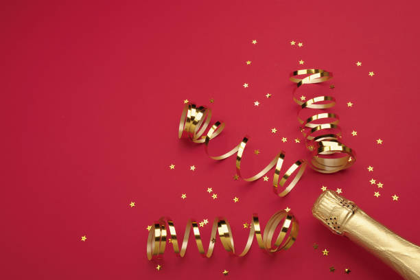 istock Champagne bottle with confetti stars on color background, space for text 1748386042