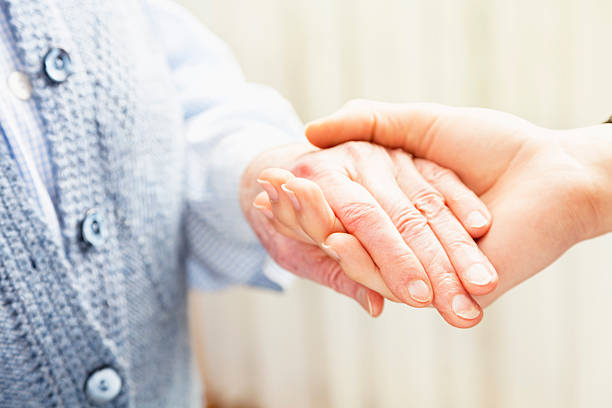 istock young woman  holding old persons  hand care 174838741