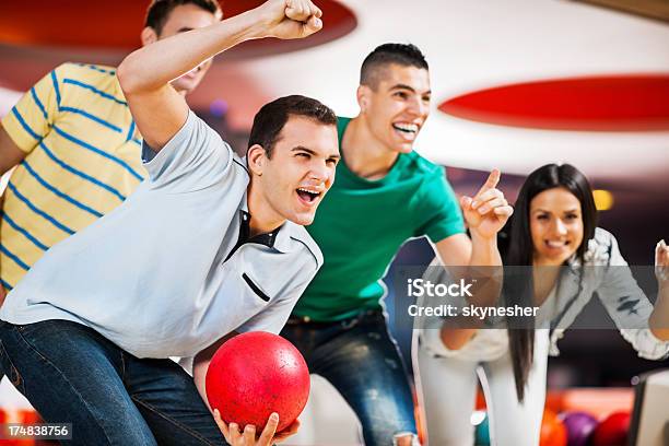 Happy Ecstatic Friends Supporting Their Bowling Team Stock Photo - Download Image Now