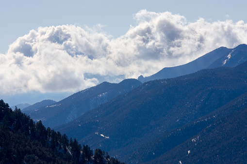 Spring clouds billow east of Ute Pass in the Colorado Rockies