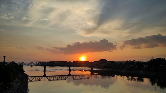 Natural silhouettes scenery sunrise background of bridge on the river during sunrise