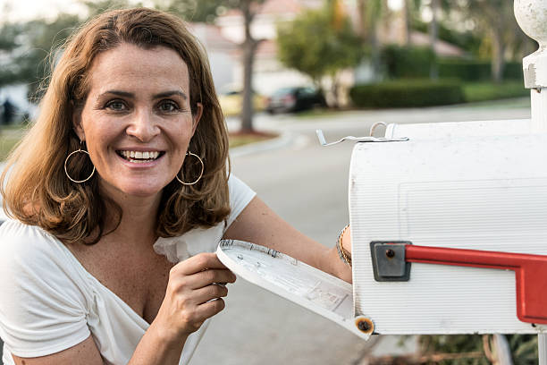 istock Woman picking up the mail 174840939