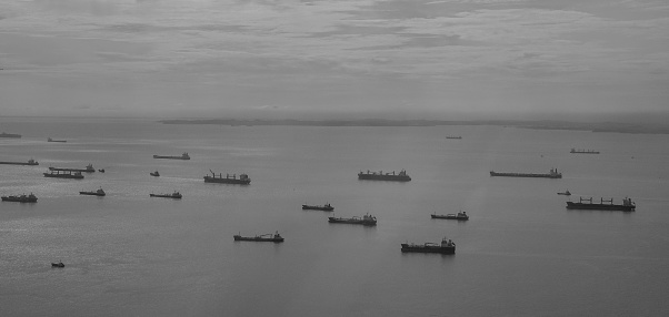 Cargo boats on the sea in Singapore. View from a window of airplane.