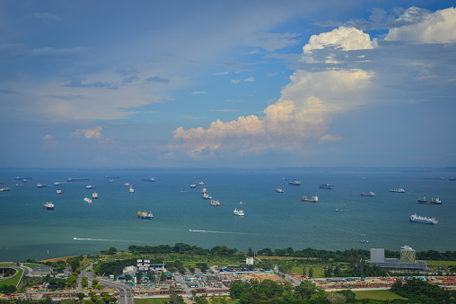 Cargo boats on the sea at sunny day in Singapore. Singapore is one of the most popular travel destinations in the world for a lot of reasons.