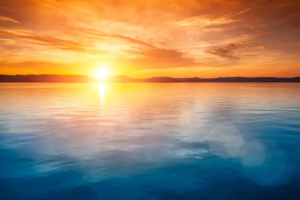 Photo of Sunset over water