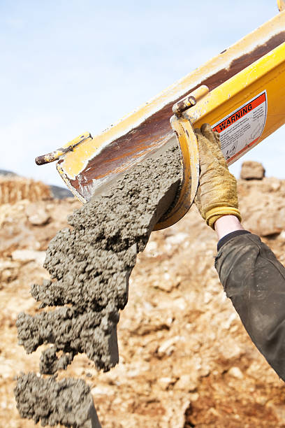 istock Construction Worker Guiding Cement Mixer Truck Trough 174841411