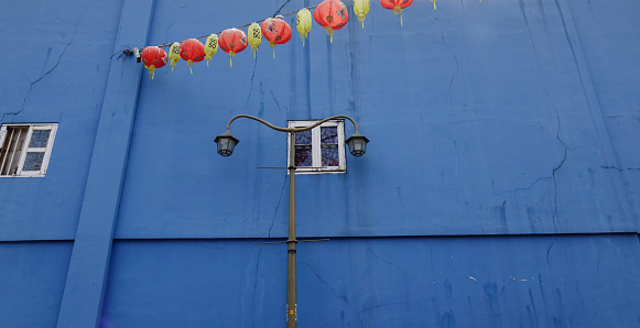 Blue wall with hanging lanterns in Chinatown, Singapore. Chinatown has had a historically concentrated ethnic Chinese population.