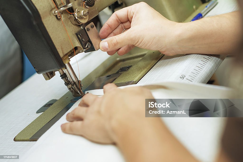Sewing hands Hands sewing with old sewing machine. Antique Stock Photo
