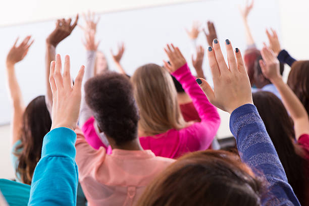 istock Diverse group of college students raising hands in class 174841983
