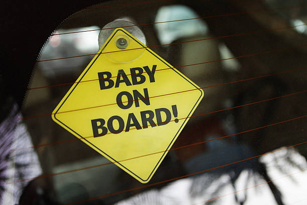 baby on board yellow car Sticky sign stock photo