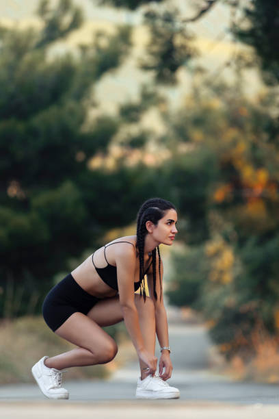 istock Beautiful fit woman exercising in nature alone 1748429096