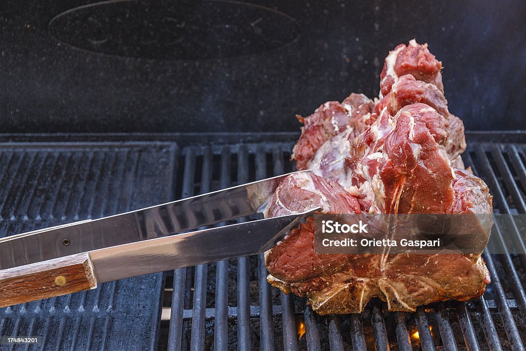 T-bone Steaks  on the BBQ Grill T-bone steaks on the BBQ Grill. Barbecue - Meal Stock Photo