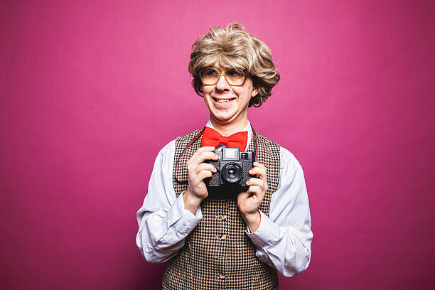 istock Nerdy Pink Background Photographer Student Young Man Making Silly Face 174843294