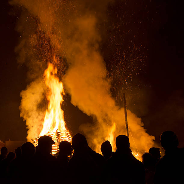 istock people standing in front of fire at night 174843394