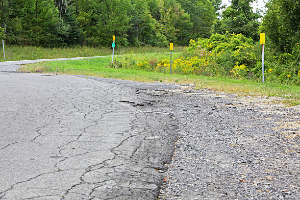 istock Asphalt Cracked on Rural Road 174843723