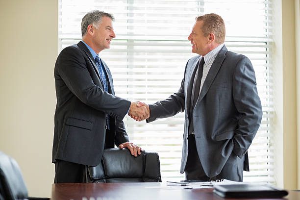 istock Businessmen Shaking Hands In Meeting Room 174844146