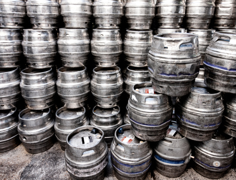 A large stack of alluminium beer kegs, Dorset, UK