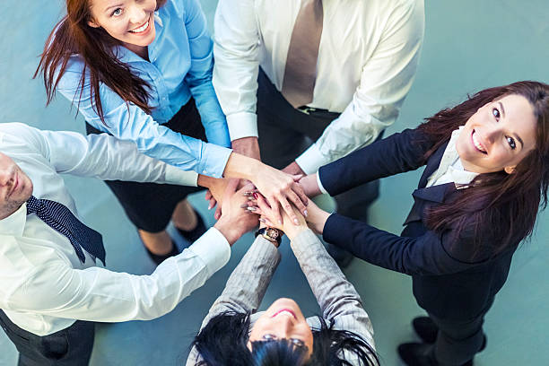 istock Unity of successful business people holding hands 174844310