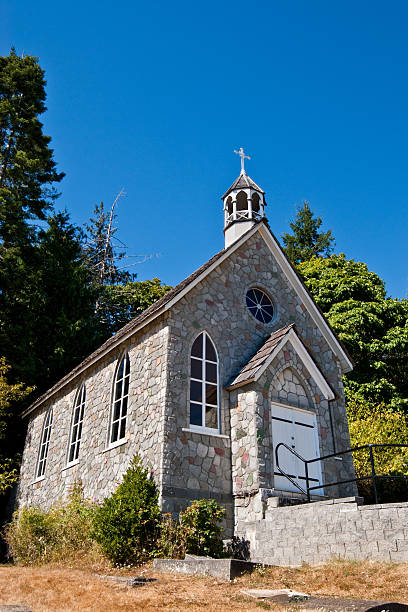 Historic Stone Church The Canadian Gulf Islands are part of a rocky archipelago in the Strait of Georgia between Vancouver Island and the mainland of British Columbia. The larger archipelago includes the San Juan Islands in the United States. The Gulf Islands are perhaps best known for their natural beauty, farms, wineries, rural lifestyle and Mediterranean climate. Activities to be enjoyed in the Gulf Islands includes boating, kayaking, hiking, camping and wildlife viewing. This area was charted by British explorer George Vancouver during his 1791-1795 expedition. The name “Gulf Islands” comes from “Gulf of Georgia,” the original name used by Vancouver on his maps. This scene was photographed at Saint Paul's Catholic Church (1880) near Fulford on Saltspring Island, British Columbia, Canada. jeff goulden church stock pictures, royalty-free photos & images