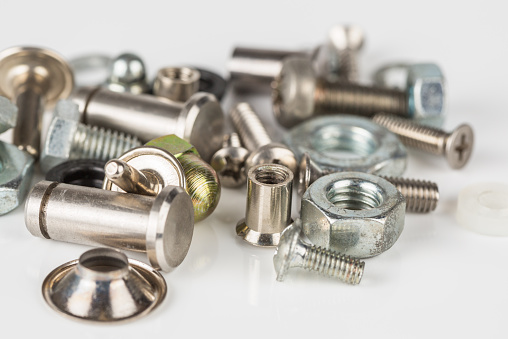 Group of steel nuts and bolts.