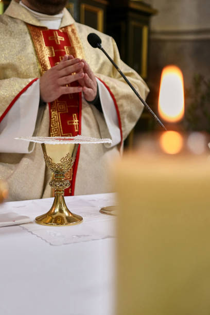 istock The priest prays before the chalice with wine for Holy Communion. 1748449393