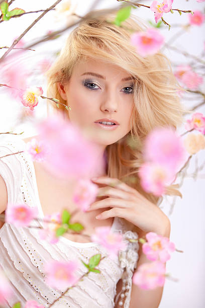 istock beautiful woman with spring flowers 174845321