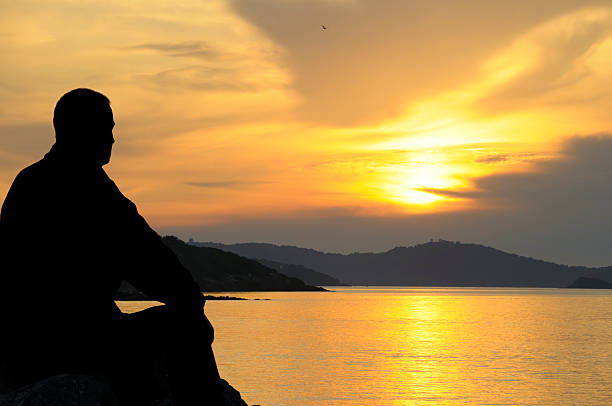 istock Silhouette of a man at sunset 174845354