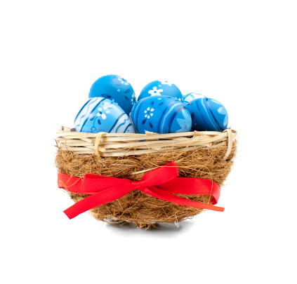 Blue Easter Eggs in the nest. The white background.