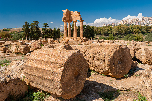 Two big columns in the Valley of the Temples of Agrigento; the temple of Dioscuri in the background
