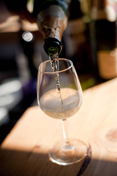 istock White Wine Pouring From Bottle to Glass in Celebration 174846292