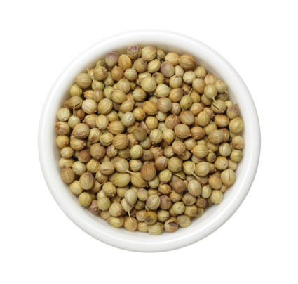 Top view of white bowl full of Coriander