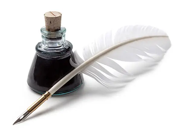Ink bottle and feather quill pen on white background