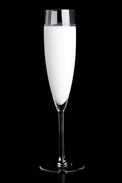 latte in un bicchiere di champagne - luxury milk dinner glass foto e immagini stock