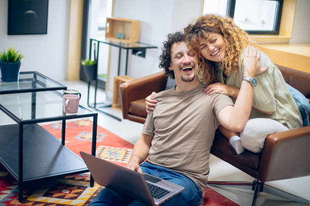 istock Young couple using laptop together 1748474771