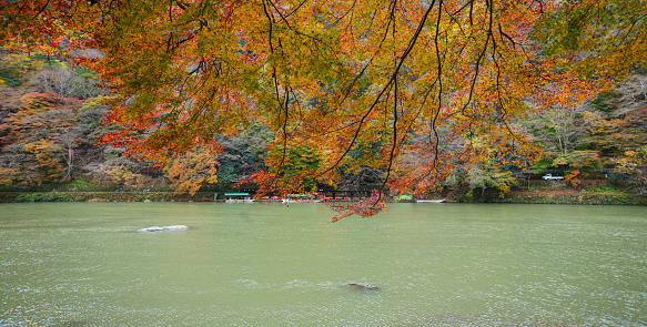 Autumn scenery with the lake at Arashiyama town in Kyoto, Japan.