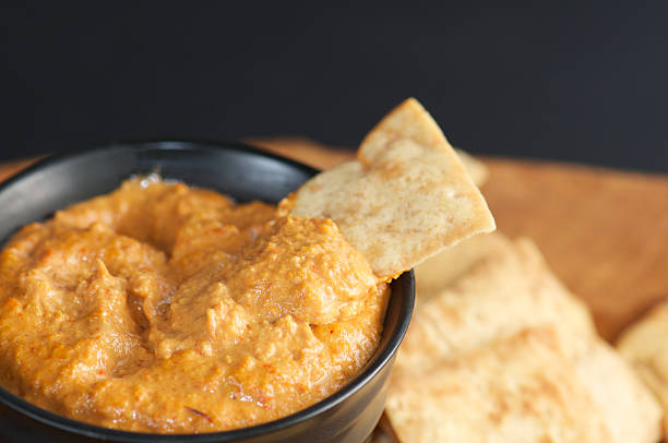 istock Red Pepper Dip with Pita Chips and Black Background 174847620
