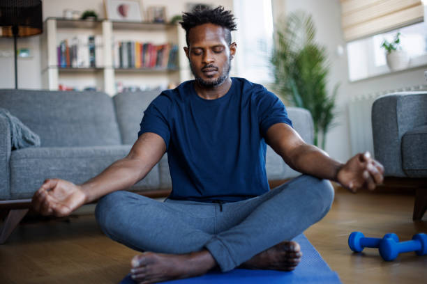 istock Man practicing yoga exercise at home in the morning 1748478742