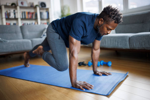 istock Shot of man making abdominal exercises at home 1748478745
