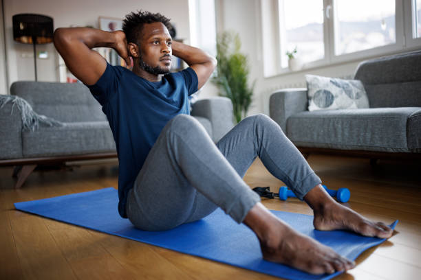 istock Shot of man making abdominal exercises at home 1748478752