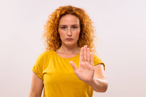 Ginger woman showing stop sign