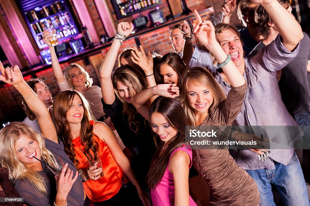 Friends Dancing At A Party Friends enjoying Party At The Club, dancing and drinking cocktails.  Celebration Stock Photo