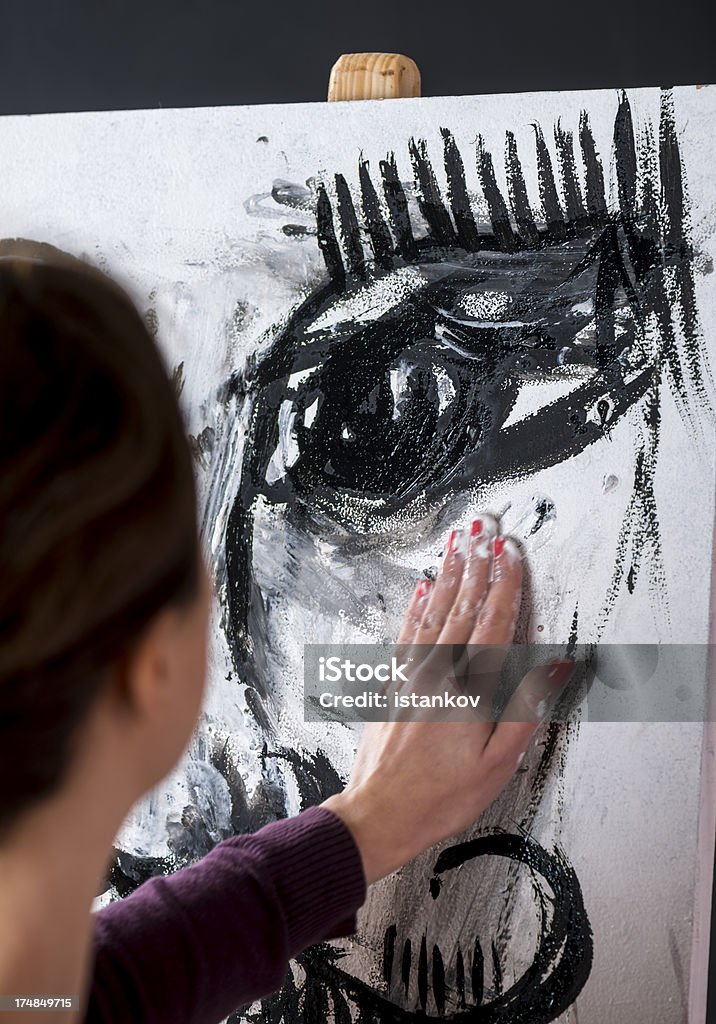Painting the Eye Female painter paints an eye on white canvas. 30-39 Years Stock Photo