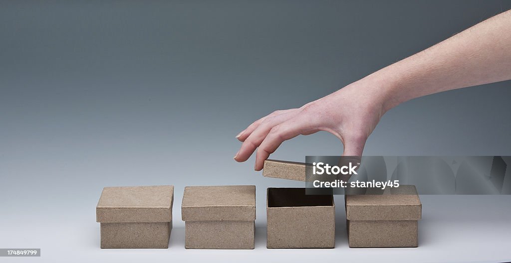 What’s inside? Female hand lifting the lid of a small cardboard box Box - Container Stock Photo