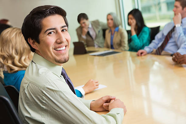 istock Young professional businessman looking back during executive board meeting 174849837