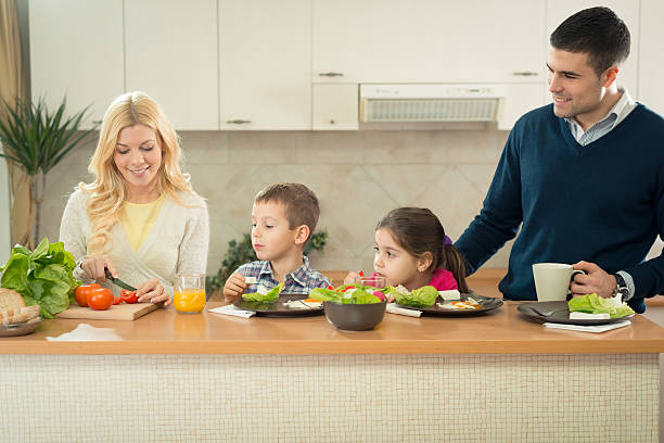 istock Happy family having breakfast together in the kitchen 174849839