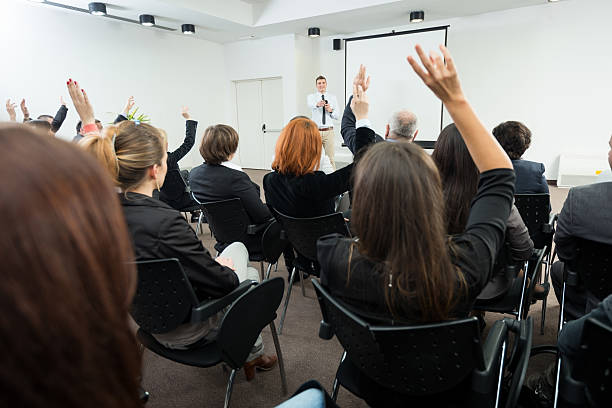 istock Business people raising hands in seminar 174850196