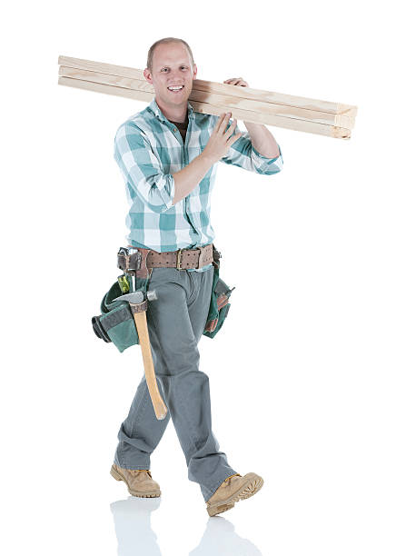 istock Carpenter carrying wooden planks and smiling 174850707