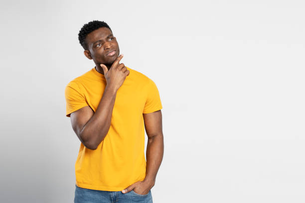istock Pensive african man standing isolated on white background, looking away, copy space, place for text 1748511196